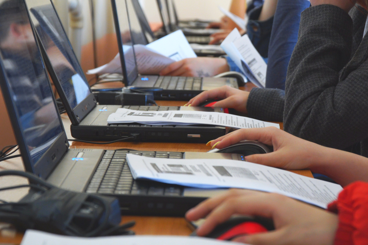 Students in a computer class. Students in front of computers in a computer class technology training